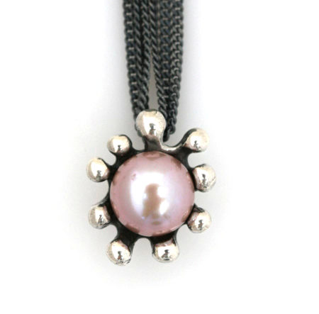 Close up af lang halskæde med søanemone vedhæng med rosa perle. Håndlavet af Christel Kaaber Guldsmedie